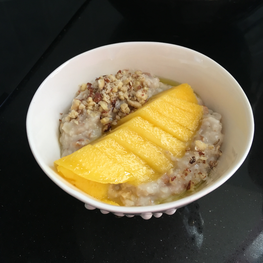 A bowl of oatmeal with fruit
Description automatically generated