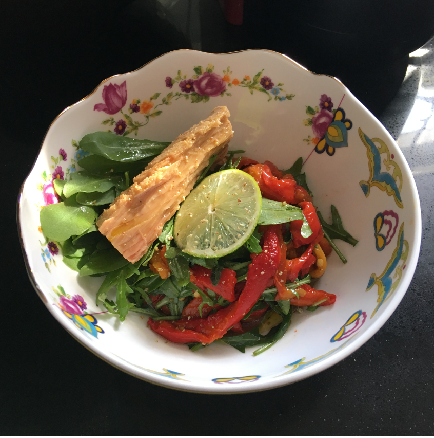 A bowl of food with a lime wedge
Description automatically generated